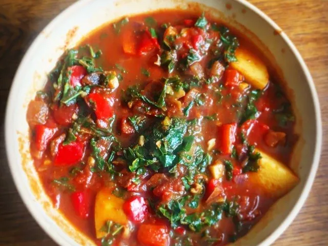 A bowl of hot Spicy Chorizo Soup with fresh kale.